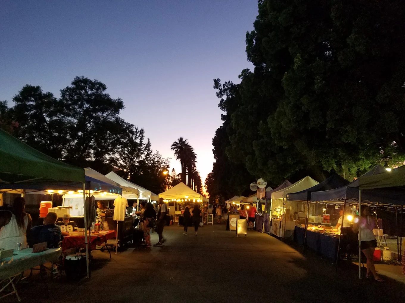 San Dimas night market tents lit at dusk in the City Hall parking lot