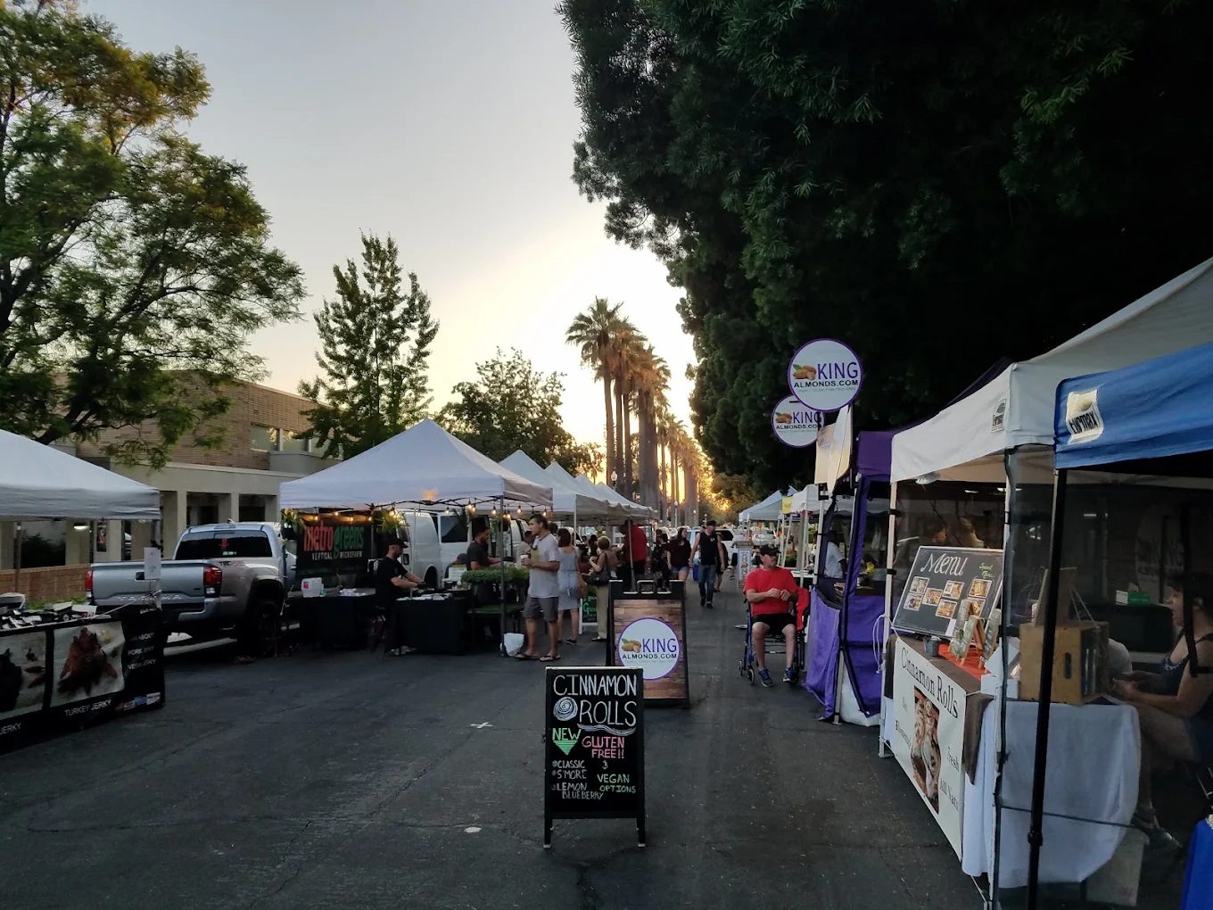 Market tents at sunset along the aisle